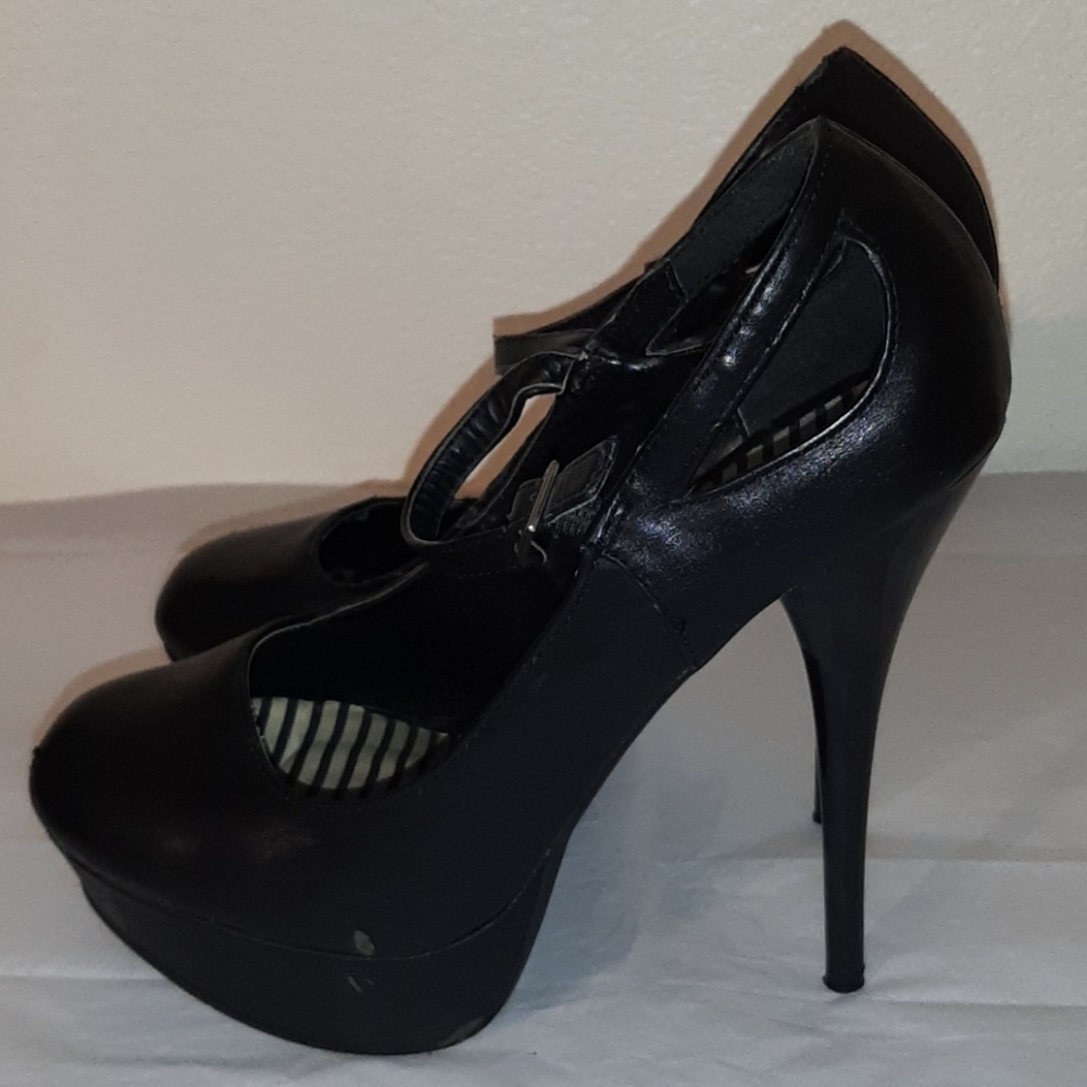 Worn black platform pumps size 7
